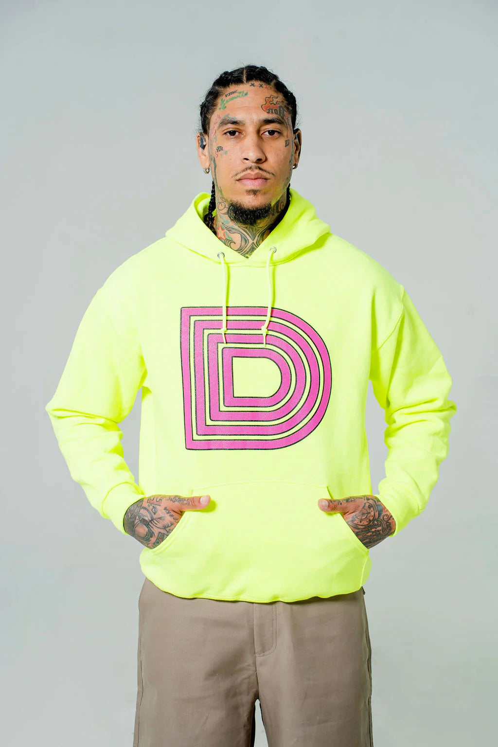 Neon yellow hoodie with a prominent pink D logo.