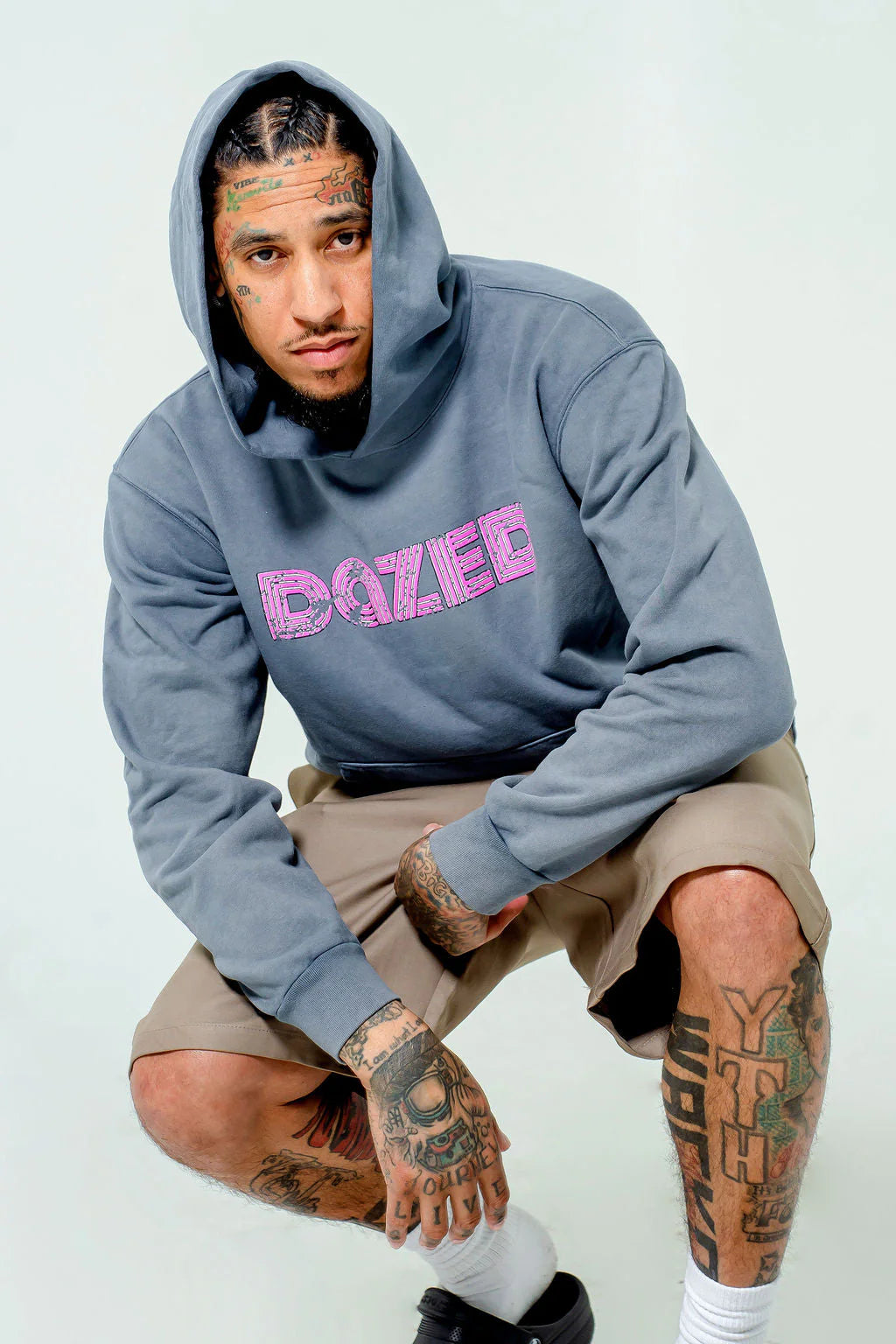 Concrete colored hoodie with a prominent pink Dazed logo.