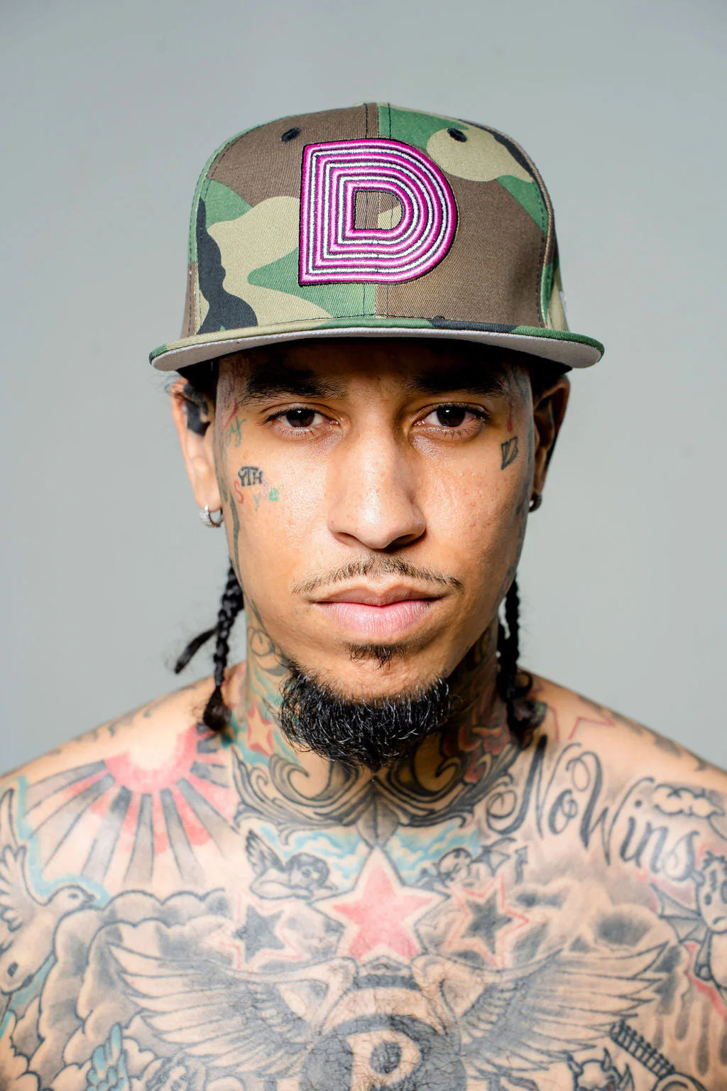 Product photo of camouflage fitted cap with a large D logo.