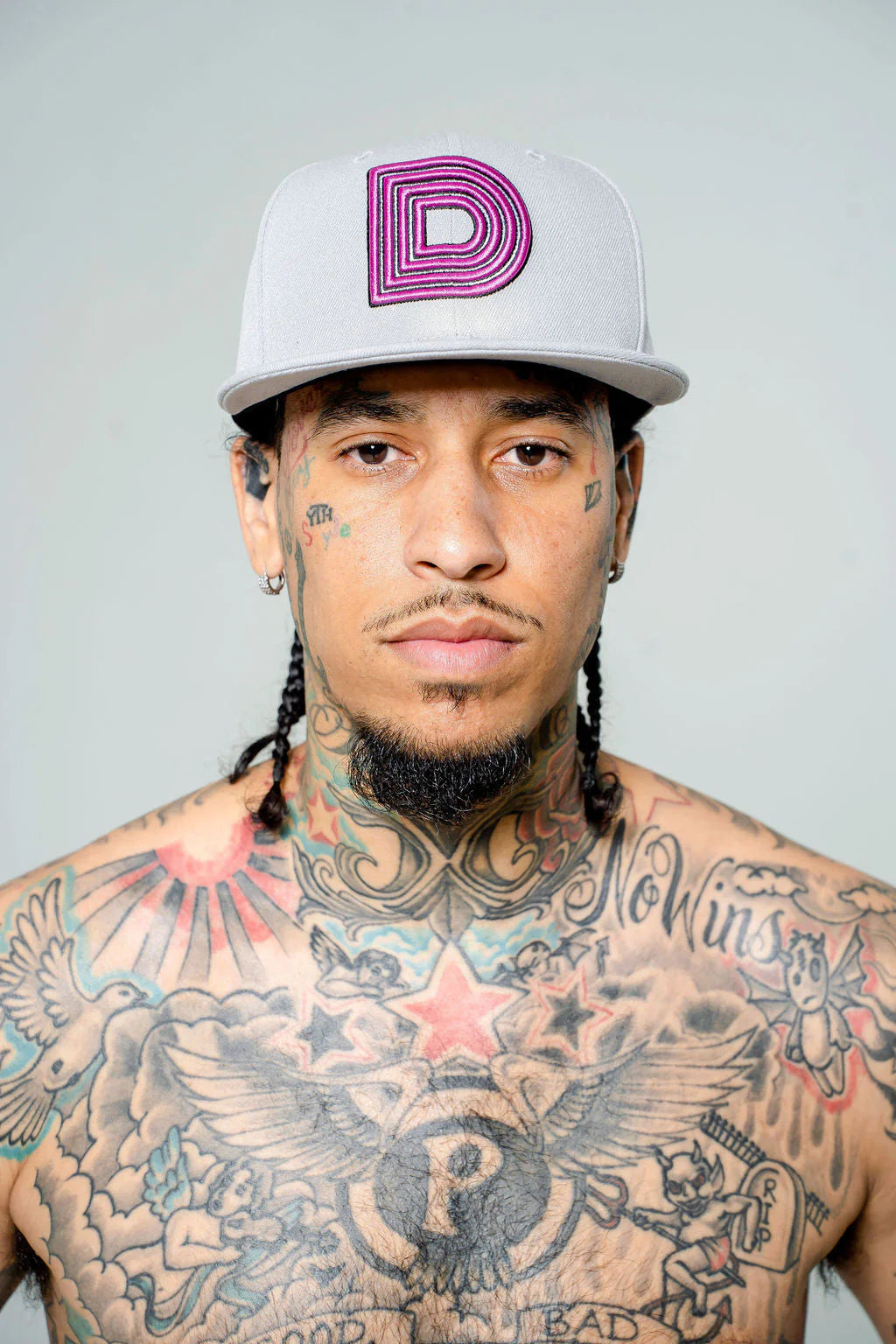 Product photo of white fitted cap with a large D logo.