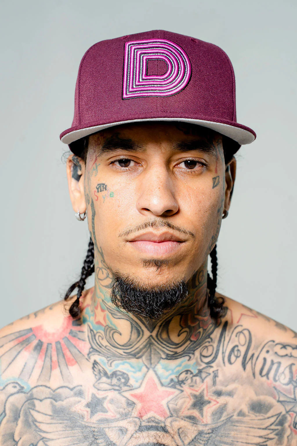 Product photo of maroon fitted cap with a large D logo.